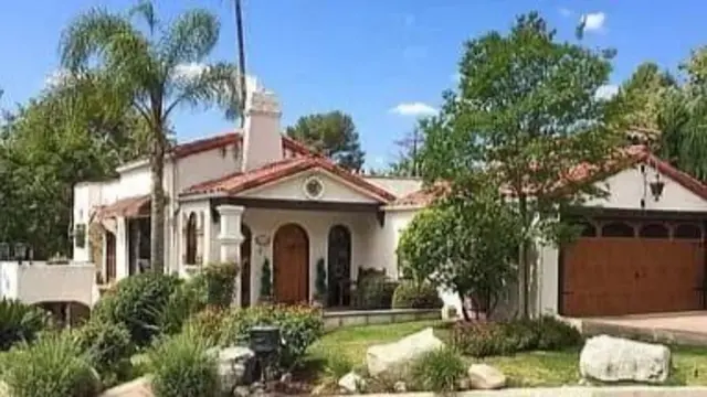 File image of a big house with some trees and other greenery around it