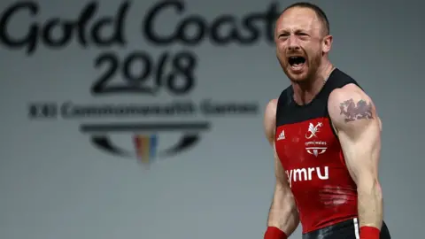 Getty Images Gareth Evans following his gold medal winning lift in the men's 69kg category