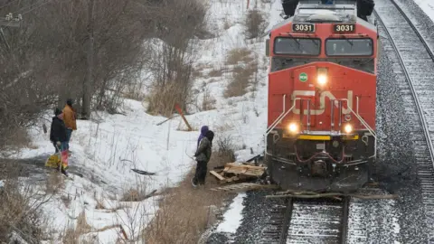 Reuters A CN Rail train moves by wooden pallets placed by occupants of a Mohawk Territory encampment