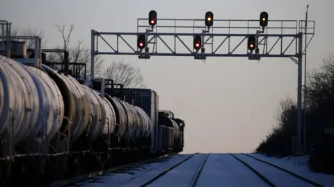 Reuters A CN Rail freight train remains halted a few kilometres from a blockade