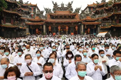 Reuters People holding joss sticks pray to the sea goddess Mazu for rain amid an island-wide drought, during a religious ceremony at Jenn Lann Temple in Taichung, Taiwan on March 7, 2021.
