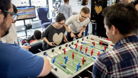 Getty Images Employees of Smarkets play table football during their lunch break at their office in central London on March 12, 2018