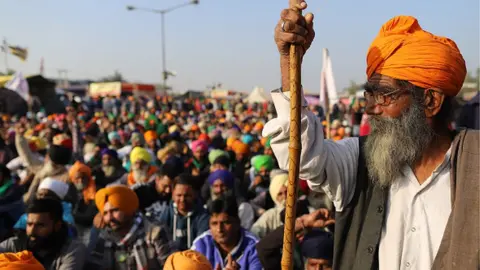 Getty Images Farmers gather at a protest site during a protest against the newly passed farm bills at the Delhi- Haryana border in Tikri, New Delhi, India, on December 14, 2020. (Photo by Amarjeet Kumar Singh/Anadolu Agency via Getty Images)
