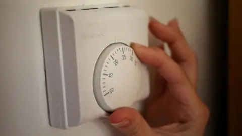 PA Media Person using a central heating thermostat