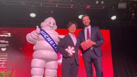 BBC Chef Ryusuke Nakagawa from Toronto Japanese restaurant Aburi Hana posing with the Michelin man.
