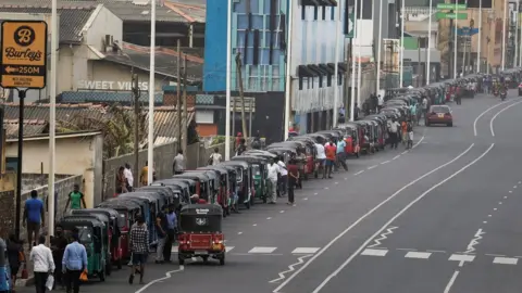 Reuters Three-wheelers queue to buy petrol due to fuel shortage, amid the country's economic crisis, in Colombo, Sri Lanka, in July.