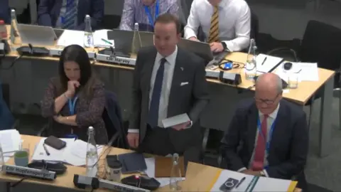 Suffolk County Council Richard Rout speaking at a council meeting