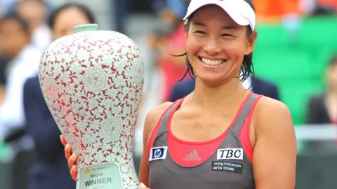 AFP Kimiko Date holds the winner's trophy at the Korea Open Tennis championship in Seoul on September 27, 2009.