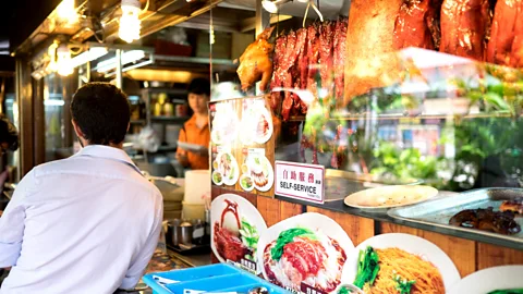 Phillip Bond/Alamy It’s easy to find chicken rice at street food stalls, such as this one on Orchard Road (Credit: Phillip Bond/Alamy)