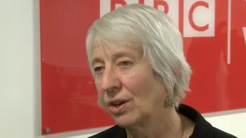 Jenny Rathbone MS, with the backdrop of a BBC sign