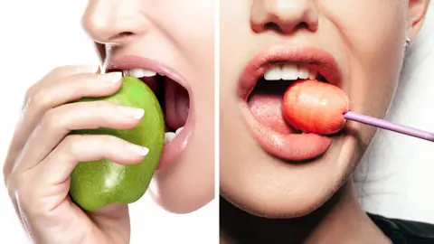 Getty Images One woman eating an apple, and another eating a lollipop