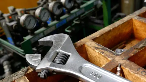 Reuters Wrench lies on a workbench at manufacturing firm