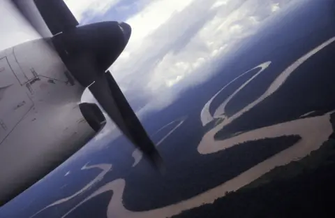 Getty Images A small plane flying over the Amazon