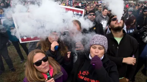 AFP Demonstrators vape during a consumer advocate groups and vape storeowners rally outside of the White House to protest the proposed vaping flavour ban in Washington DC on 9 November 2019.