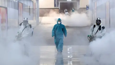 Reuters Volunteers disinfect a railway station in Hunan province, China, 4 February 2020