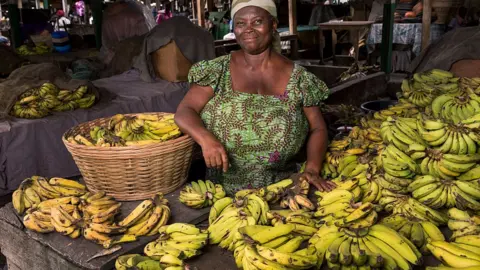 Getty Images Informal worker Rebecca Paintsil selling bananas at Kantamanto market August 10, 2015 in Accra