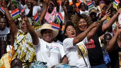 Getty Images People waving The Gambian flag