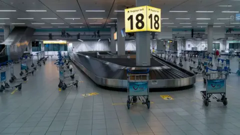 Getty Images An empty baggage reclaim area at Schiphol International Airport in Amsterdam