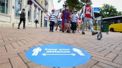 Getty Images Sign reminding shoppers to maintain 2m distance