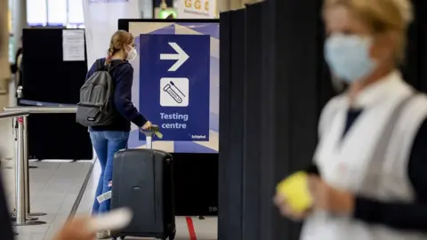 EPA A woman enters the coronavirus test area at Amsterdam Schiphol Airport