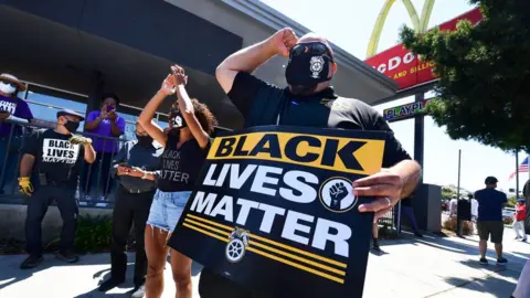 Getty Images Activists protest in front of a McDonalds in Los Angeles, California, on July 20, 2020 during a Strike For Black Lives rally.