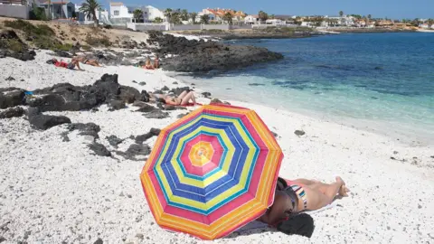 EPA People enjoy a warm day at the beach of Corralejo, Fuerteventura, Canary Islands