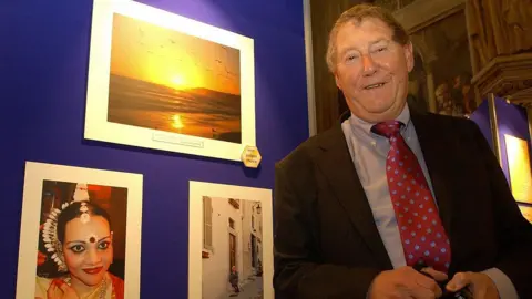 PA Media Austin Mitchell with photographs