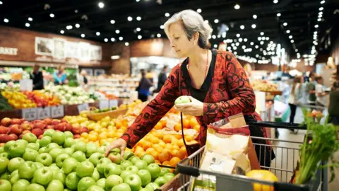 Getty Images Woman buying fruit in supermarket