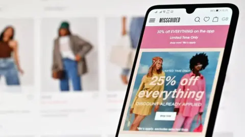 Getty Images A mobile phone showing the Missguided website