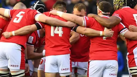 Getty Images Wales players in a huddle before they take on Scotland in the Six Nations