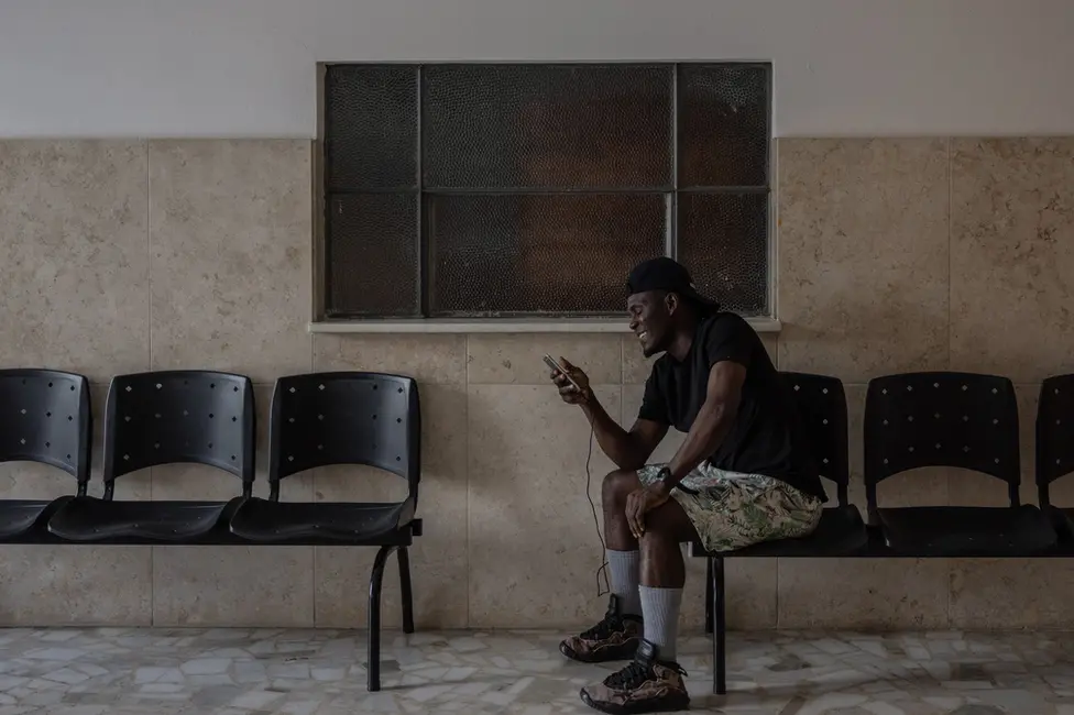 BBC Roman Friday makes a video call to his family back home. (Victor Moriyama/BBC)