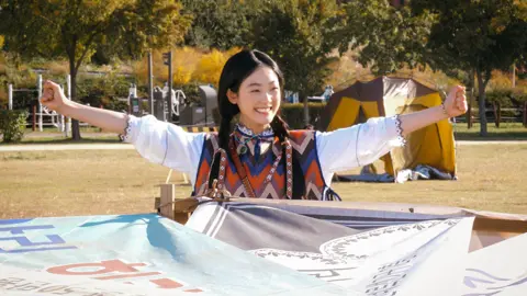 Netflix Strong Girl Nam-soon sitting under a home-made yurt in a park in Seoul