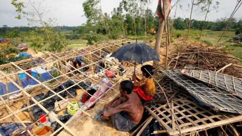 Reuters Rohingya refugees sit in front of their house which has been destroyed by Cyclone Mora at the Balukhali Makeshift Refugee Camp in Cox's Bazar, Bangladesh 31 May 2017