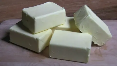 BBC Five unwrapped blocks of butter on a wooden board