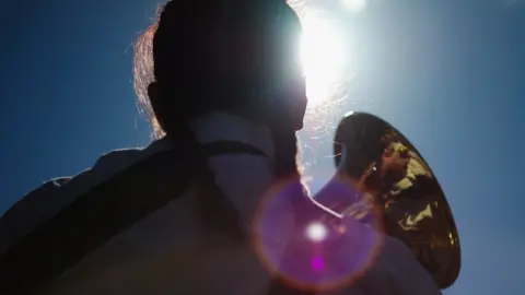 Getty Images Woman plays instrument