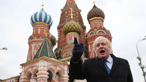 Getty Images Boris Johnson stands in front of Saint Basil"s cathedral in Red square in Moscow