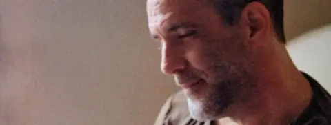 Michael Van Huffel in his apartment