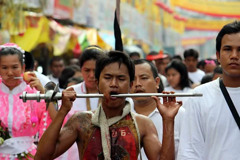 The bloody procession pounds the pavement through Phuket Town. (Kylie McLaughlin)