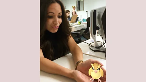 Socialfly Stephanie Cartin, of Socialfly, with a Pidgey, at her desk. (Credit: Socialfly)