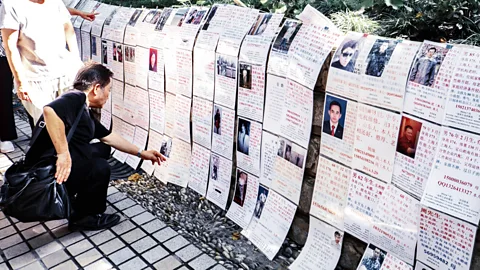 Alamy Parents scouting the competition at the marriage market wall in Shanghai (Credit: Alamy)