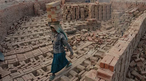 Getty Images An Indian woman works at a brick kiln on the International Women's Day in Dimapur, India north eastern state of Nagaland (Credit: Getty Images)