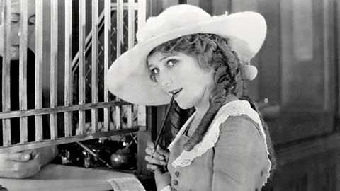 Getty Images Pickford at a bank counter in a promotional still, circa 1920 (Credit: Getty Images)