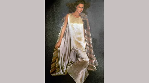 Alamy Iconic 1970s supermodel Lauren Hutton wears a two-piece pleated silk Fortuny dress and cape, 1975 (Credit: Alamy)