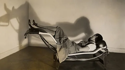 FLC/ Adagp, Paris 2019 Charlotte Perriand lounges on the chaise longue basculante, 1929 (Credit: FLC/ Adagp, Paris 2019)