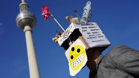 EPA A 5G conspiracy theorist with a cardboard box on his head (Credit: EPA)