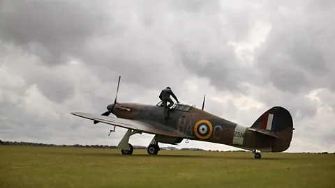 Oli Scarff/Getty Images Pilot climbing into Hurricane (Credit: Oli Scarff/Getty Images)