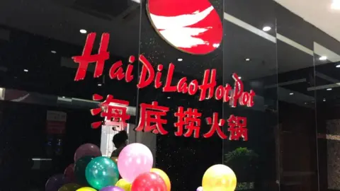 Getty Images A Haidilao Hot Pot restaurant is seen at a mall on May 22, 2018 in Beijing