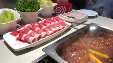 Getty Images A Haidilao Hot Pot restaurant is seen at a mall on May 22, 2018 in Beijing