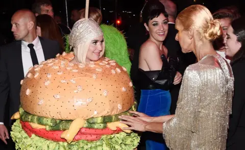 Getty Images Katy Perry dressed as a beef burger at the 2019 Met Gala, with Celine Dion
