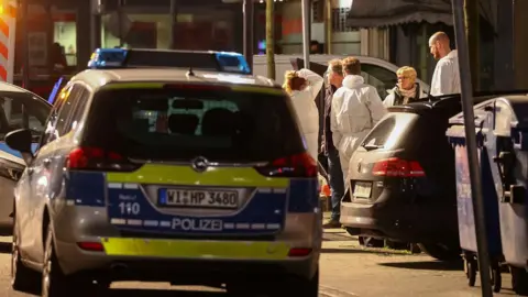 Reuters Forensic officers at the scene of one of the Hanau shootings